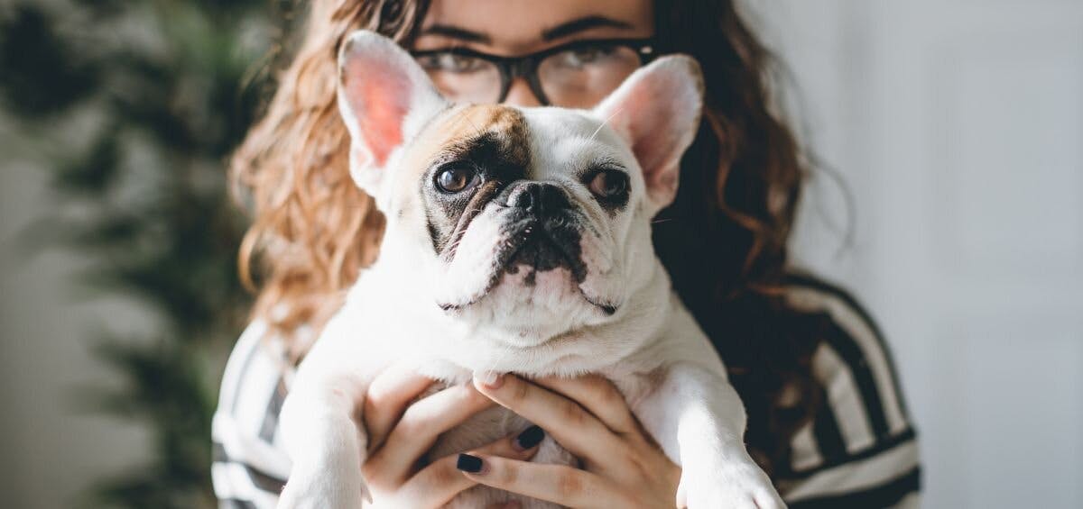woman holding dog with unique pet name